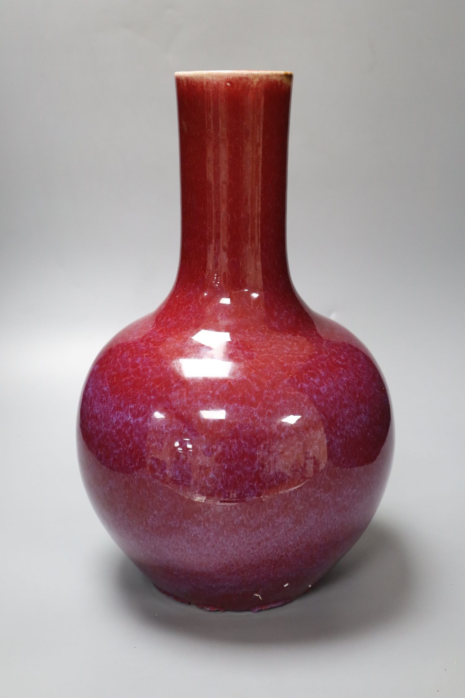 A Chinese porcelain bottle vase, Sang de boeuf glaze, height 34cm